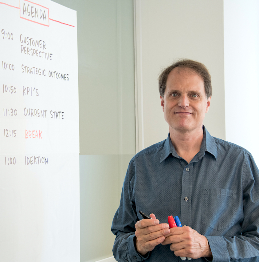 Lloyd Dangle writing out the agenda for a strategy meeting photo by Terry Lorant